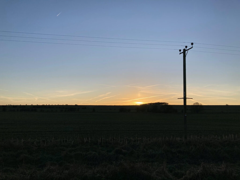 sunset over the silhouette of the ridgeway winter solstice