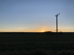 sunset over the silhouette of the ridgeway winter solstice